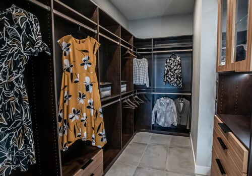 A view of the 'her' side of a two-toned, lighted custom his and hers closet in Sandalwood Community, Summerlin.