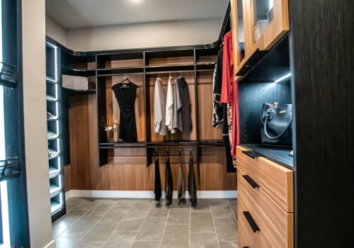 A view of the 'her' side of a two-toned, lighted custom his and hers closet in Sandalwood Community, Summerlin.