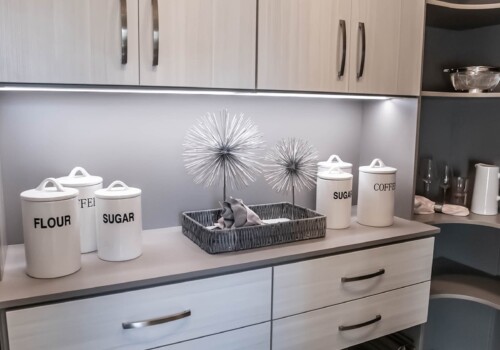 This custom pantry shelving system includes both hidden and open concept storage! The cabinets and drawers are perfect for storing necessary items that you want hidden from view, but the open concept storage allows you to create an airy feel and evaluate your necessary items at a glance. Take a look at the creative combination of hidden and open concept storage in this custom pantry shelving system in a Las Vegas model home!