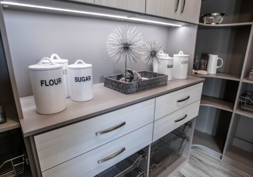 A custom pantry should include lighting to appropriately help you navigate and utilize your luxury shelving system. Here we installed built-in lighting above the tabletop, so that the home owners would be able to better see when preparing or gathering items for the kitchen. Highlight your custom pantry's unique design with luxury lighting built into the shelving system design!