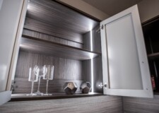 Wine glasses and accessories in a smooth-finished custom kitchen pantry cabinet by Closets Las Vegas Elegant custom kitchen pantry cabinet Las Vegas