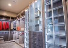 This expensive walk in closet in Las Vegas has elegant shoe racks and cabinets glass doors which are aluminium framed aluminium framed shoe racks and cabinets glass doors in an expensive walk in closets