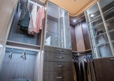 Elegant looking Las Vegas high end custom closet with aluminum-framed glass doors lighted display cabinet and crocodile pattern drawer fronts aluminum-framed glass doors lighted display cabinet and crocodile pattern drawer fronts