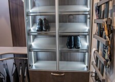 This luxury shoe rack for him in a high end custom closets in las vegas has a smart lighting system for him shoe rack in a high end custom closets in las vegas