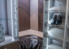 The aluminum-framed glass doors lighted shoerack and custom drawers for closet look pleasingly graceful in this expensive walk in closet in Las Vegas Sophisticated aluminum-framed glass doors lighted shoe rack and custom drawers for closet