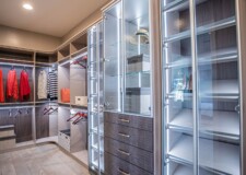 Outstanding crocodile pattern drawer fronts and lighted display cabinets in a high end custom closet in Las Vegas Elegant looking for her closet with crocodile pattern drawer fronts and lighted display cabinets