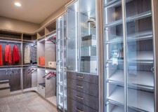 Outstanding crocodile pattern drawer fronts and lighted display cabinets in a high end custom closet in Las Vegas Elegant looking for her closet with crocodile pattern drawer fronts and lighted display cabinets