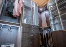 This expensive walk in closet in Las Vegas has elegant custom drawers for closet and aluminum framed shelf glass doors custom drawers for closet and aluminum framed shelf glass doors in an expensive walk in closet