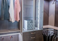 Functional and stylish luxury closet design by Closets Las Vegas luxury closet design crocodile texture drawers and lighted display cabinet with hampers
