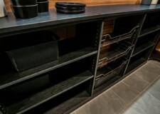 This custom kitchen pantry design in a Sandalwood model home project looks absolutely stunning with its dark shaded shelves and steel baskets Walk In Kitchen Pantry Ideas Las Vegas, NV