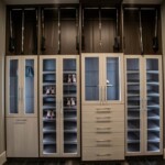 The sophisticated Her side of luxurious closet in a master bedroom with his and hers closets in Las Vegas has white shaded wooden cabinets for a clean look.