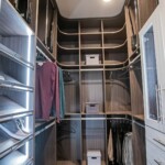 Upon entry to the His side of this luxurious closet in a master bedroom with his and hers closets in Las Vegas, you'll be stunned by its elegant design.