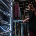 The his side of this walk-in closet in a master bedroom with his and hers closet in Las Vegas has an ample space packed in one corner.