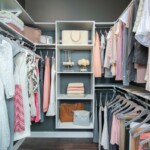 Close view of the closet with corner chrome rods and stack for bags and other things.