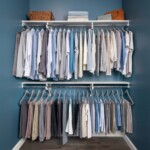 Modern white closet with double hang chrome rods and white upper shelves