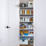 Empty bedroom with open doors leading to the livingroom, bathroom and a closet Adjustable Closet System Las Vegas, NV