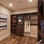 Her side of the closet with long hang, shoe shelves, and a cabinet
