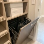Perfect for professionals on the go, this efficient closet design has a pull out hamper you can use to keep your laundry.