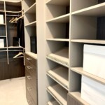 This men's closet features an efficient design with shoe shelves and soft close cabinet.