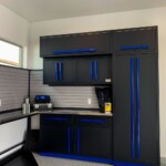 This custom garage has overreaching top cabinets that lock in place.