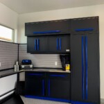 This custom garage has overreaching top cabinets that lock in place.
