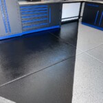 This custom garage floor boasts three coatings to provide protection from dirt and damage. No matter the season, the garage floor will remain shiny and looking new.