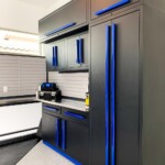 This garage features black stainless steel cabinets and shelves.
