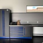 Full custom garage cabinets in black stainless steel with blue handles.