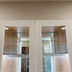 Keep your purses in this glass enclosed cabinet with true lighting!