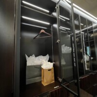 Inside the glass door of this custom walk in closet.