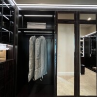 Another interesting detail: this custom walk in closet has upper AND lower mirrored doors.