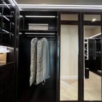Another interesting detail: this custom walk in closet has upper AND lower mirrored doors.