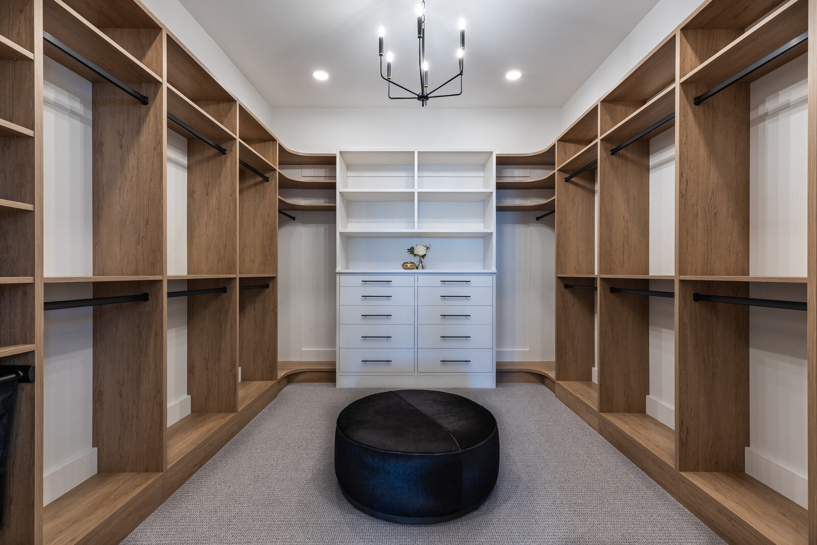 Boutique-style custom walk-in closet with chandelier