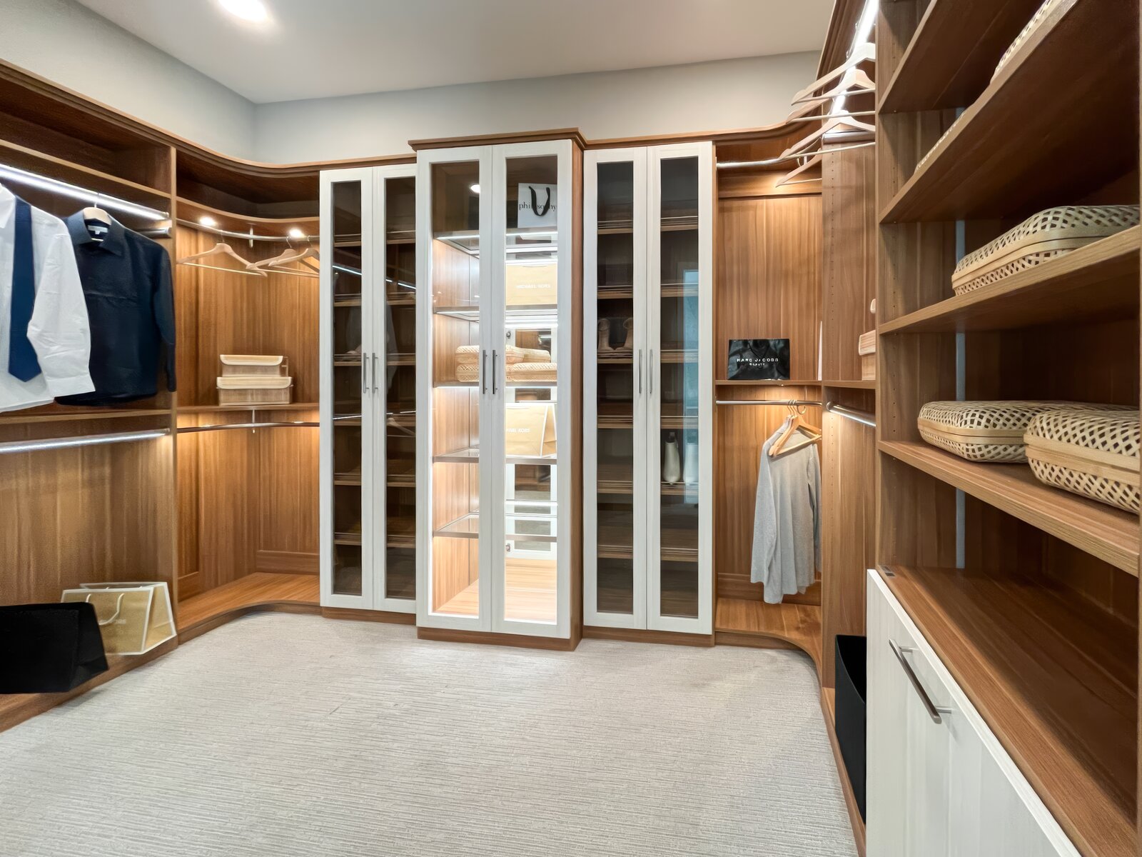 Custom walk-in closet with wood tower and white glass doors